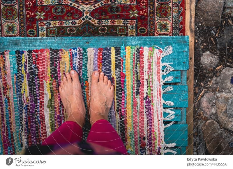 Bare feet standing on colorful carpets foot bare feet barefoot pattern art fabric texture old design decoration vintage persian textile oriental rug cloth craft