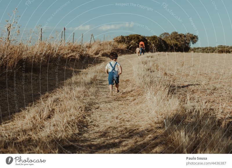 Rear view child running through fields Child 1 - 3 years Day Playing Leisure and hobbies Nature Joy Toddler Exterior shot Human being Infancy Colour photo