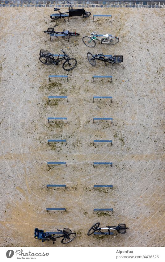 Partially | occupied bicycle parking Wheel bicycle stand Bicycle Exterior shot Parking lot Cycling Bicycle rack Town Means of transport Deserted Transport