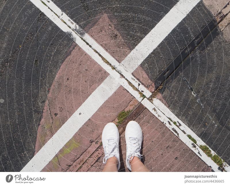 X marks the spot x white sneakers shoes feet legs pavement street art graffiti urban concrete