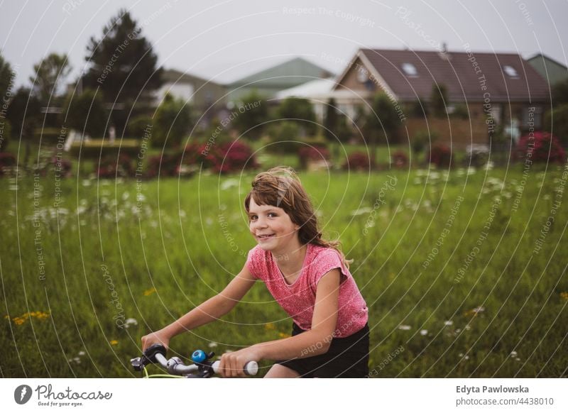 Little girl riding bicycle in the countryside Dutch Europe Holland Netherlands bike cycling riding bike cycle routes vacation travel active adventure summertime