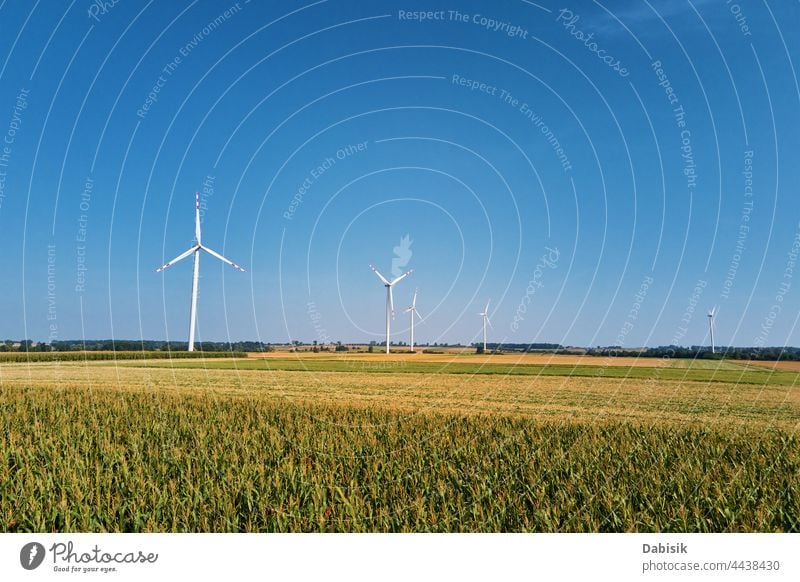 Windmill turbine in the field at summer day. Rotating wind generator energy windmill technology propeller sustainable landscape eco electric concept industry