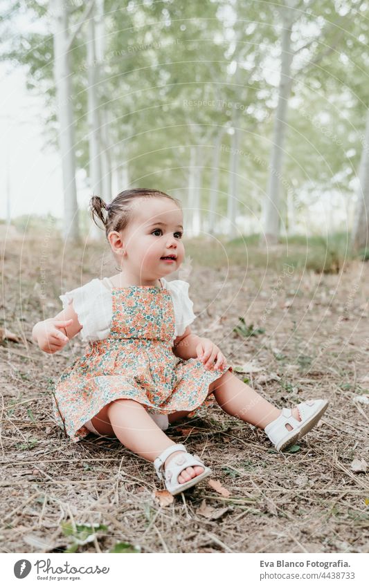 happy baby girl having fun outdoors in trees path. Children, fun and nature concept forest childhood smiling run caucasian Spain dress innocent innocence