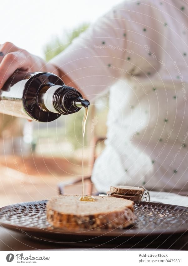 Crop person pouring syrup on slice of bread breakfast food terrace summer add sweet tasty delicious fresh table nutrition dessert yummy meal treat plate morning