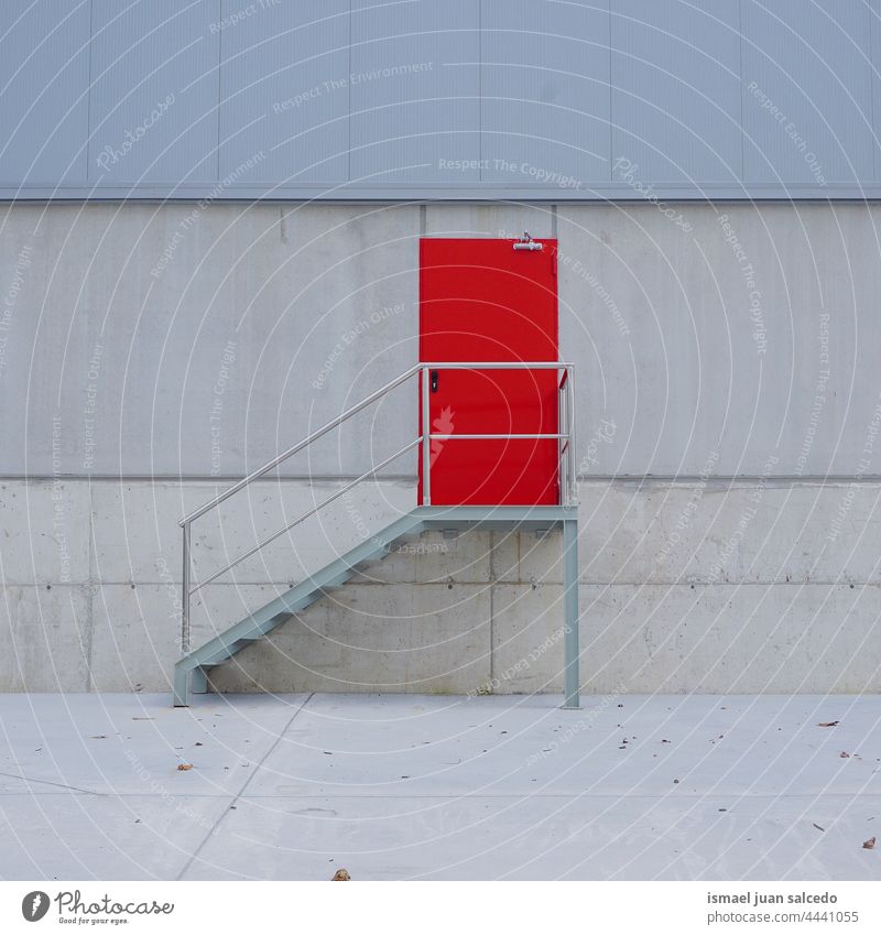 metallilc red door on the facade of the building metallic texture pattern background abandoned street outdoors wall front architecture exterior stairs