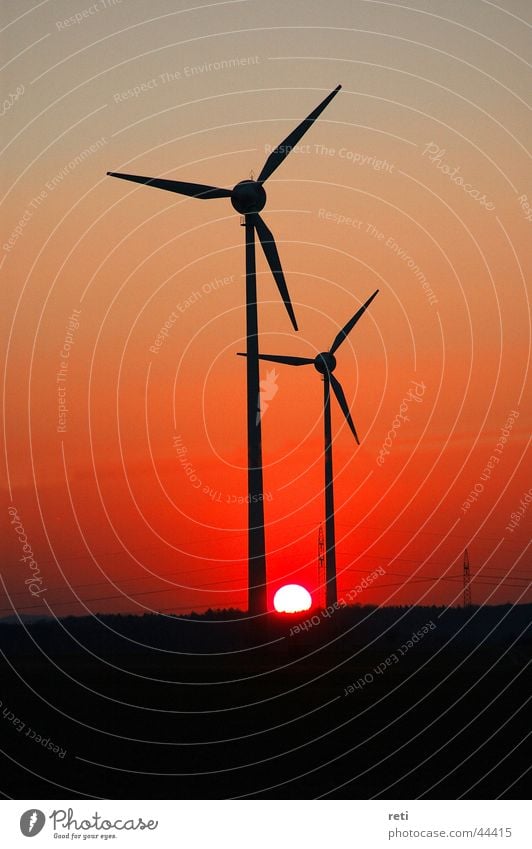 Windmills in the evening sky Red sky Back-light Sunset Evening sun Wind energy plant Generator Electrical equipment Technology Dusk