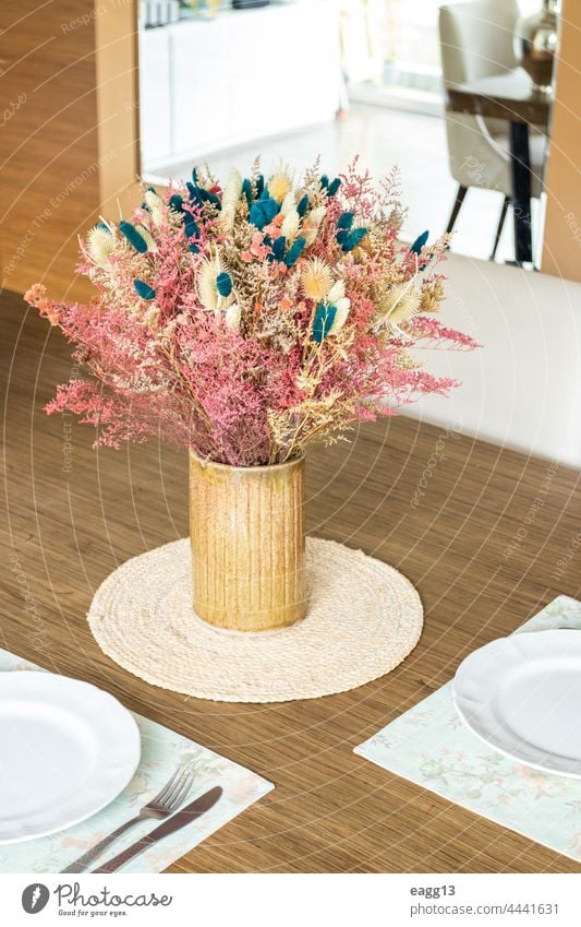 Plate and utensils, on the table decorated with a small flower arrangement border centerpiece cloth napkin conceptual contemporary copy space copyspace crockery