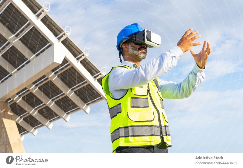 Engineer experiencing virtual reality in goggles against construction inspector experience technology simulator entertain man using gadget uniform device