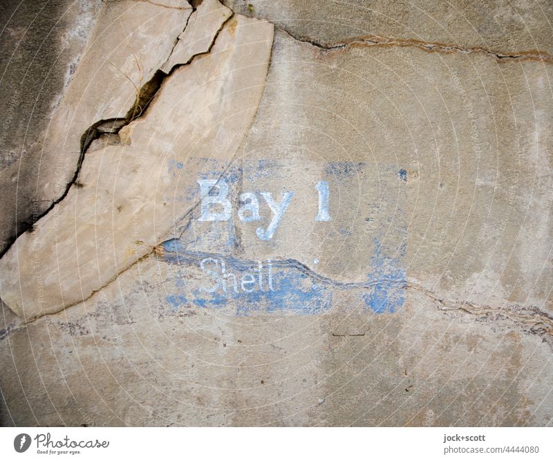Bay 1 Shell designation on cracked wall Wall (barrier) Historic Old Lettering English Characters Stencil letters Detail Word Weathered brittle Defence Fastening
