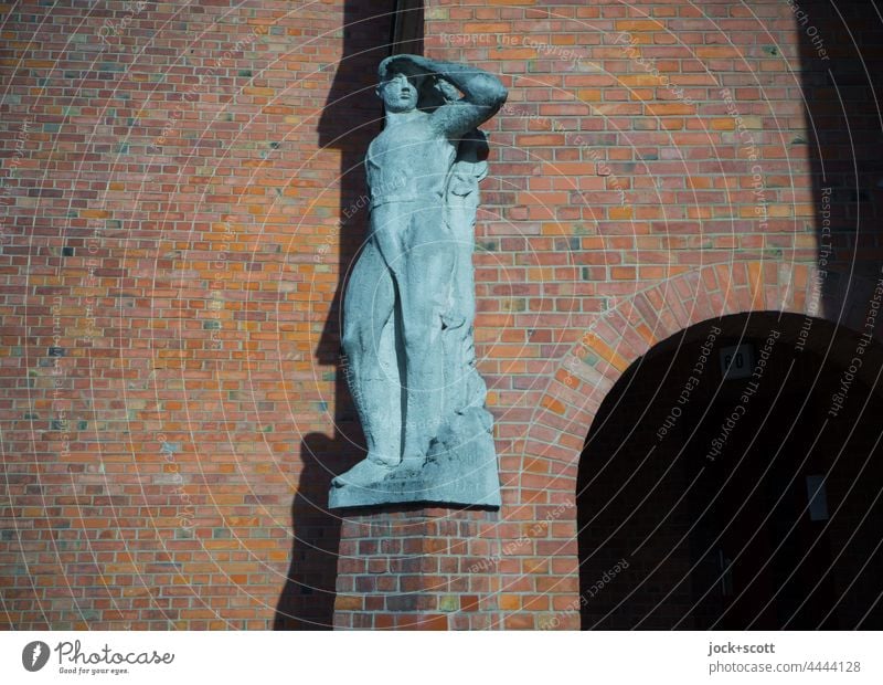 Stature in front of the facade with clinker brick Statue Wall (building) Old Facade Sunlight Pedestal Shadow Reinickendorf Berlin Round arch art in construction