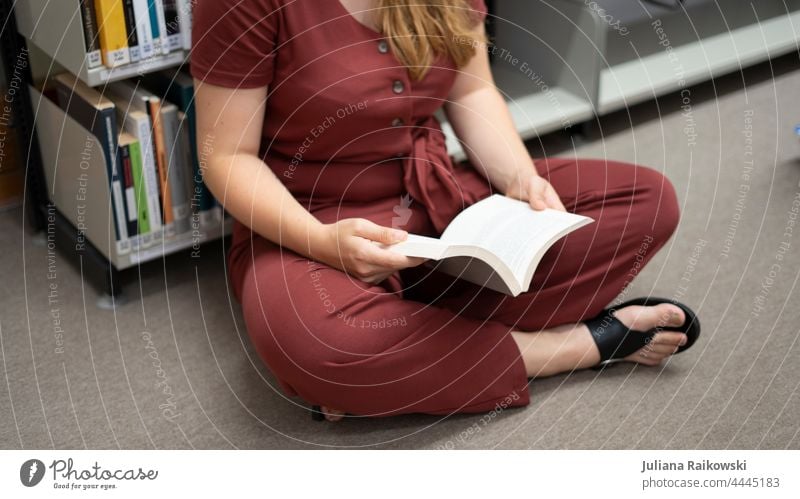 Woman sitting on the floor reading a book Book Reading Education Study Academic studies Know Library Literature Information Wisdom School Science & Research