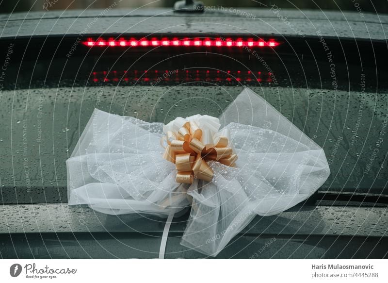 wedding decoration on the back of the car rainy day background beautiful beauty black blue bouquet bow box bridal celebration city closeup color decorative