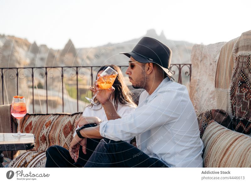 Stylish man drinking Aperol Spritz in bar aperol spritz cocktail style cool alcohol cold chill male beverage relax beard young sunglasses terrace trendy booze