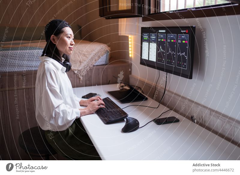 Serious ethnic female trader analyzing cryptocurrency market statistics woman analyze data using monitor diagram workplace finance internet busy economy