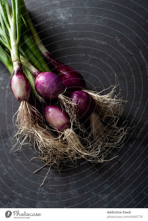Raw purple onions places on table ripe fresh food organic raw ingredient nutrition green stem healthy food vegetable vitamin natural edible product culinary