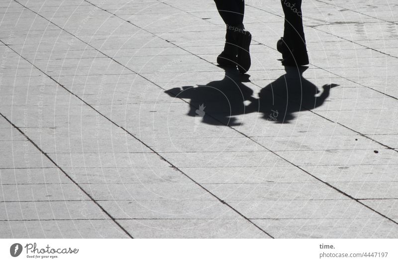 pair skating Couple at the same time feet In transit Places Floor covering Concrete slabs sunny urban Shadow crossing Silhouette Back-light in common in twos