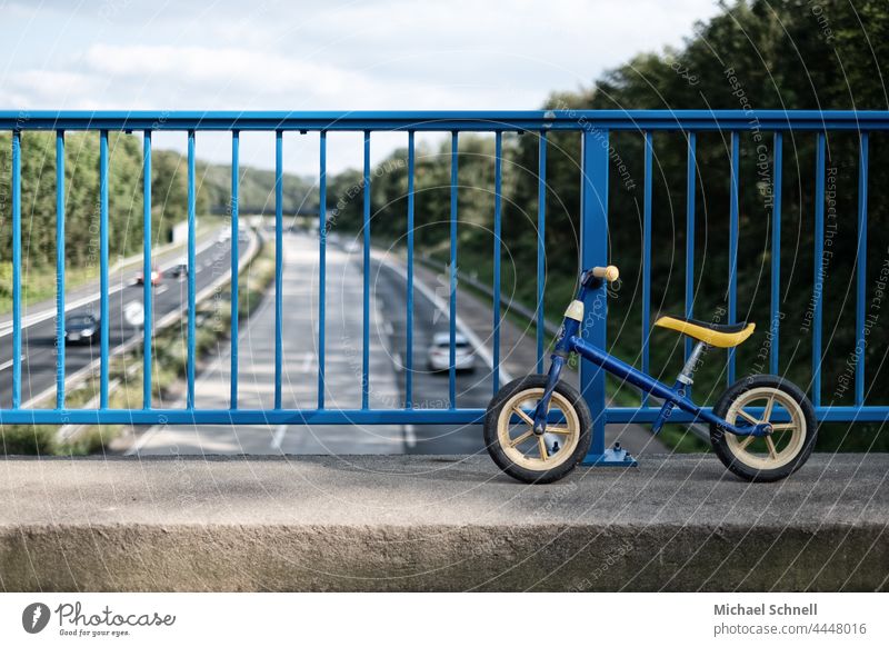 Old wheel on a bridge over the highway impeller Child Infancy Exterior shot Movement Toddler Bicycle Playing Former Past Review Longing melancholically