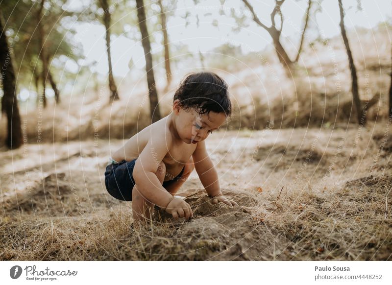 Child playing with soil childhood Dirty dirt Playing Infancy explore Environment Summer Innocent Happiness Happy Lifestyle Joy Nature Cute Day Exterior shot
