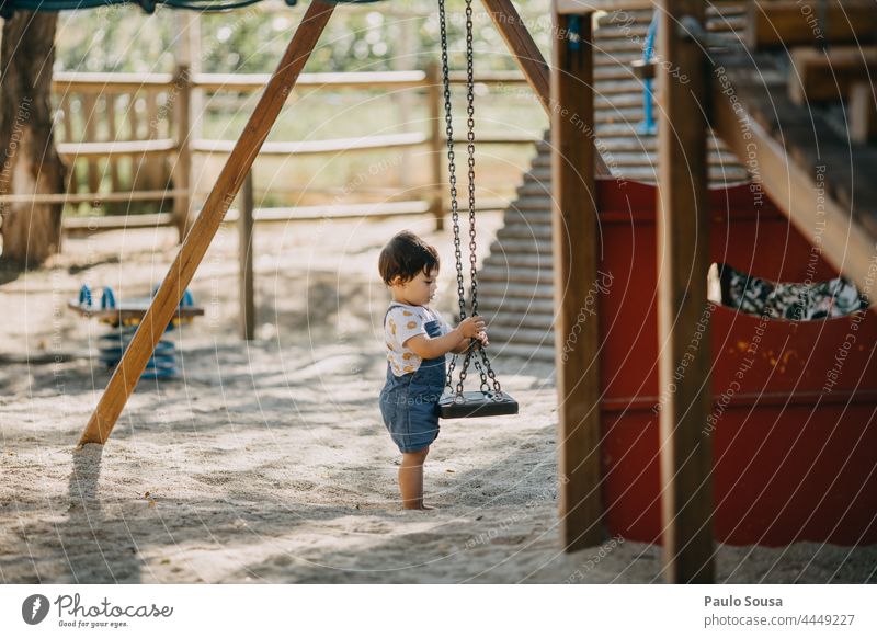 Child playing in the playground childhood Playing Playground playground equipment Slide Park Human being Childhood memory Toddler Day Kindergarten Infancy