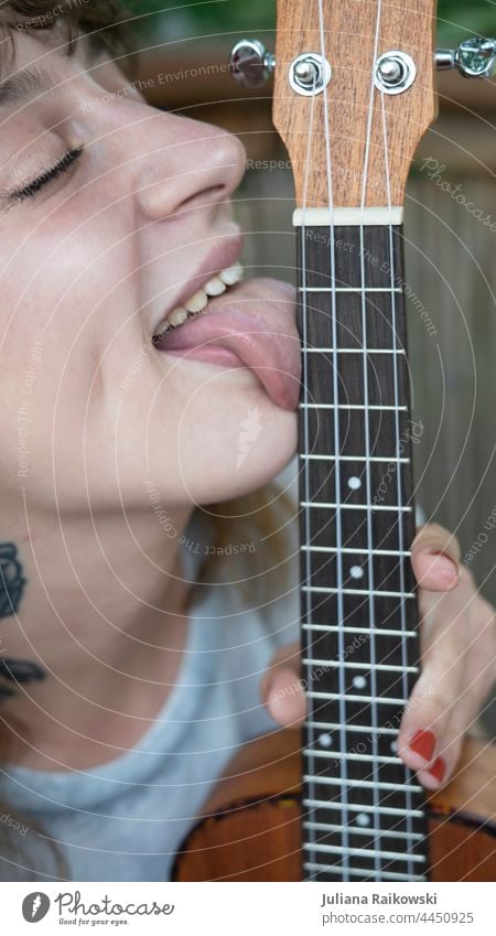 Wife licks guitar Guitar Music Concert Rock music Leisure and hobbies Musical instrument Acoustic Colour photo Guitar string Close-up Wood Make music Musician