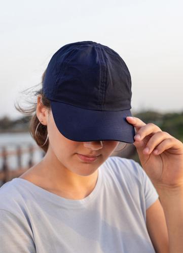 Teen girl in dark blue baseball cap and t-shirt outdoor teenager adolescent Caucasian mockup sea visor wearing t-shirts teen girl childhood female happiness
