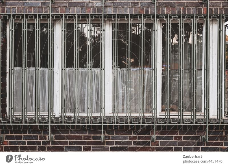 Window front, lattice, curtains and brick wall of a historical industrial building Glazed facade Grating Historic Industry Brick Wall (building) Maua Facade
