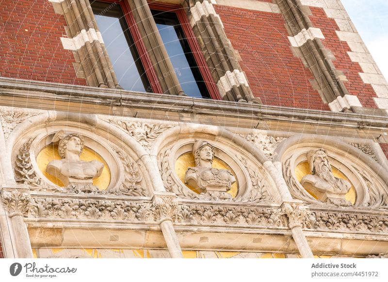 Facade of old building with carved busts architecture historic ornament culture ornate facade heritage stucco decor history medieval masonry window decorative