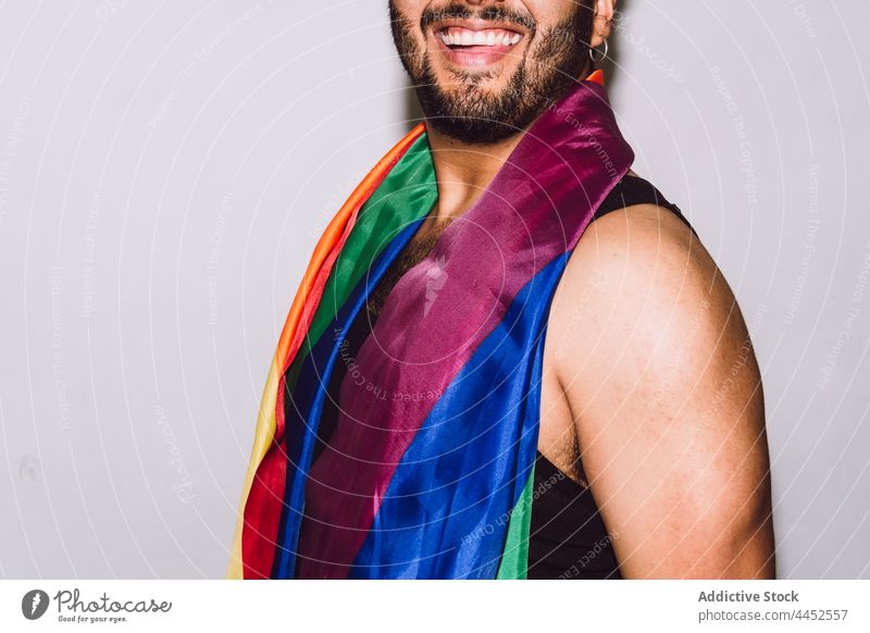 Cheerful anonymous man with mouth opened carrying LGBT flag laugh rainbow symbol right community union tolerance respect male optimist fun homosexual positive