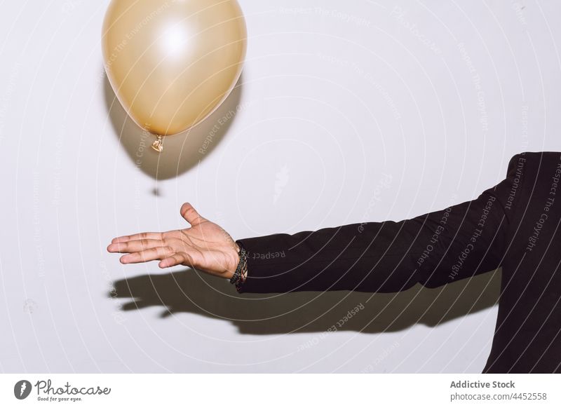 Man playing with balloon at party man event holiday celebrate occasion surprise male studio shot congratulate incognito decoration birthday fantasy anniversary