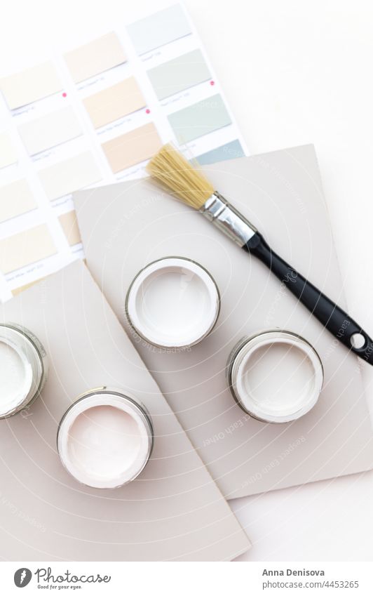 Choosing wall paints can brush pots sample choosing renovation sample pots color grey pastel plastered liquid tin bucket home house decoration paintbrush dye