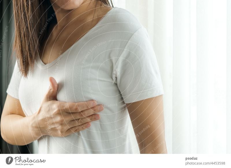 Woman hand checking lumps on her breast for signs of breast cancer. Women healthcare concept. adult anatomy asian awareness background beauty body bse bust