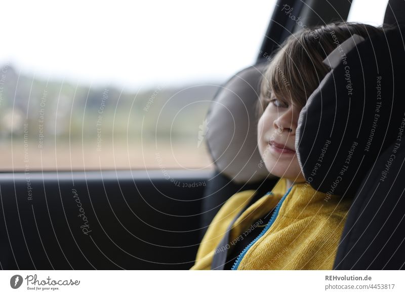 Child sitting in car seat everyday life Transport Safety sure Child seat Driving portrait Infancy Mobility mobile In transit Trip Yellow eye contact 7 years