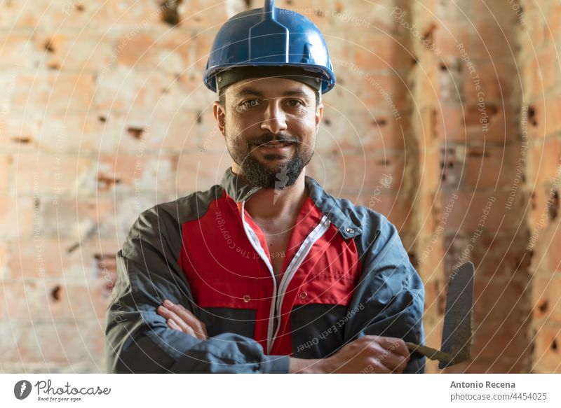 Bricklayer poses smiling while renovating a bathroom picola profile man bricklayer worker job construction arab 40s persona 35-39 years goatee indoor reforms