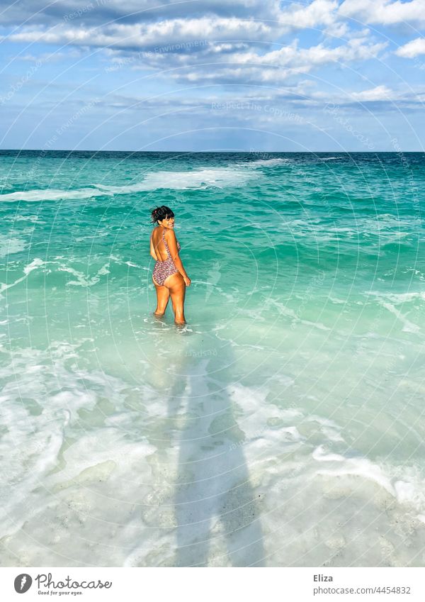 Tanned woman in bikini stands in the sea and enjoys her summer vacation Ocean Woman Bikini bathe tanned Beach vacation Swimming & Bathing Summer vacation