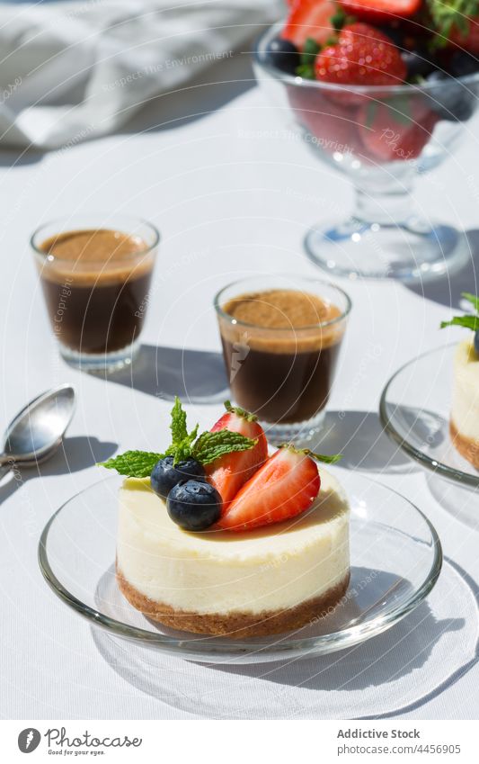 Delicious berry cheesecakes and espresso on table coffee dessert treat sweet natural delicious cafe mint vitamin plate colorful hot drink beverage strawberry