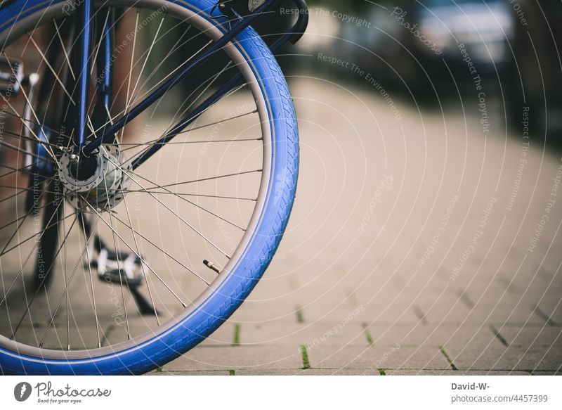 Bicycle in a city - blue bicycle tire Town Blue Bicycle tyre Wheel Cycling Spokes Sustainability Means of transport