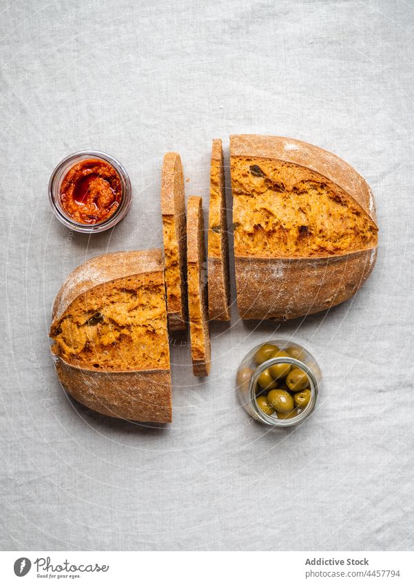 Bread and red pesto sauce on table bread tasty olive italian cuisine layout loaf food jar glass gourmet green meal nutrition ingredient delicious organic fresh