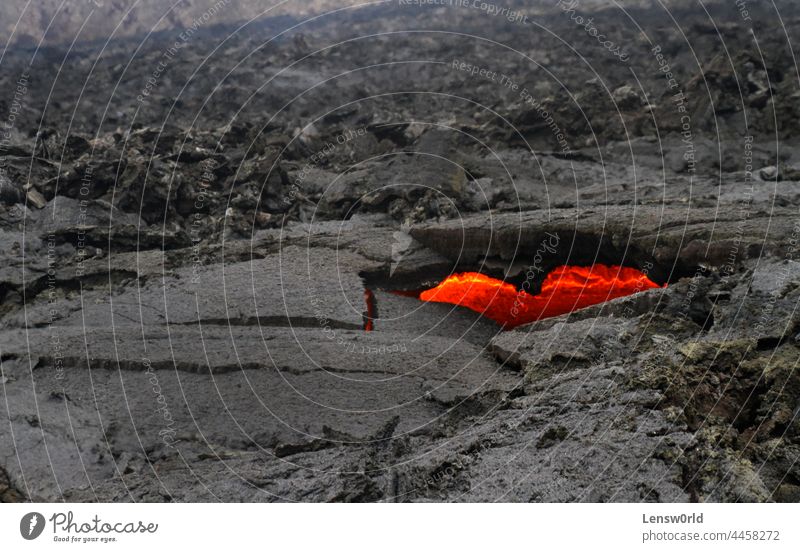 Glimpses of lava through a heart-shaped hole near Iceland's newest volcano, Geldingadalir black geldingadalir hot iceland icelandic landscape magma nature
