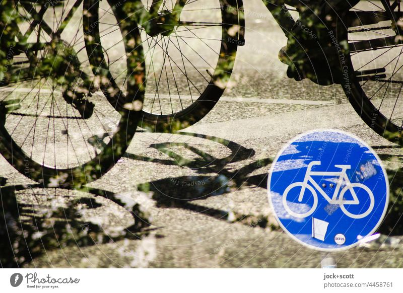 Wheels on the road with the traffic sign for cycle track Road sign Bicycle cycle path Street Sunlight Double exposure Silhouette Asphalt leaves Shadow Reaction
