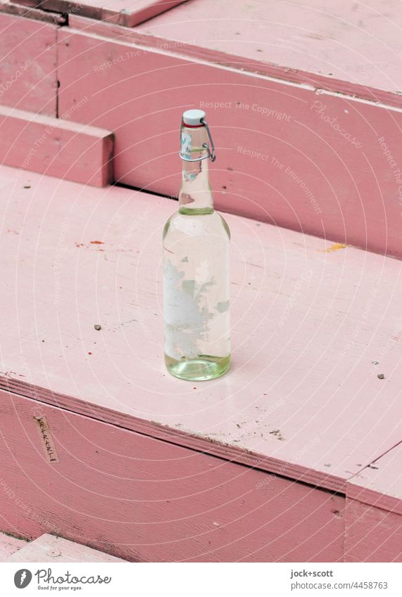 Bottle with swing top stands on a staircase Things Neutral Background Glassbottle Closure clip-on bottle Design Label torn down Pink Empty turned off Stairs