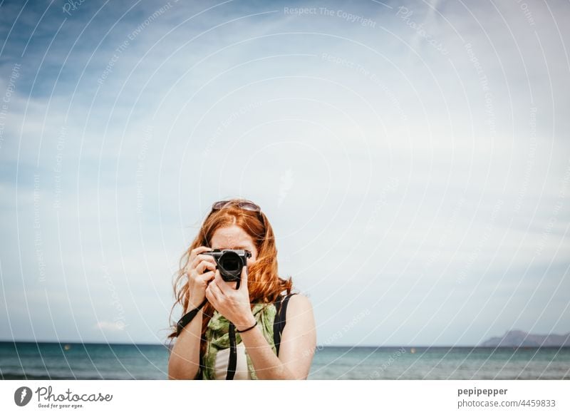 redhead woman taking vacation photos on the beach Red-haired Long-haired Feminine portrait Hair and hairstyles red-haired woman Human being Exterior shot Woman