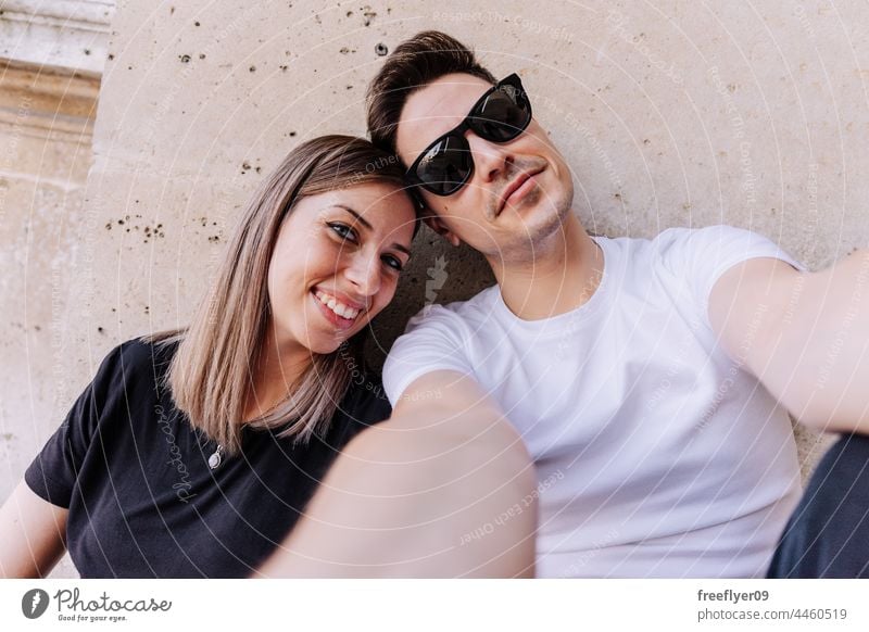 Young couple taking a selfie Selfie Couple love heterosexual young young adult boyfriend pretty home human relationships lover lifestyle caucasian stylish 30s