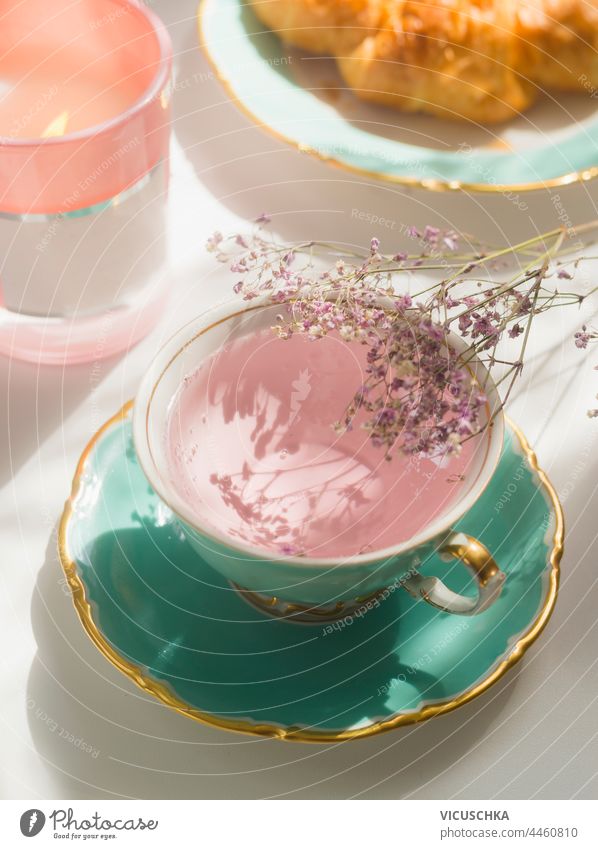 Close up of pink flowers tea in turquoise teacup on sunny breakfast table close up tea time authentic background drink floral healthy natural rose roses summer