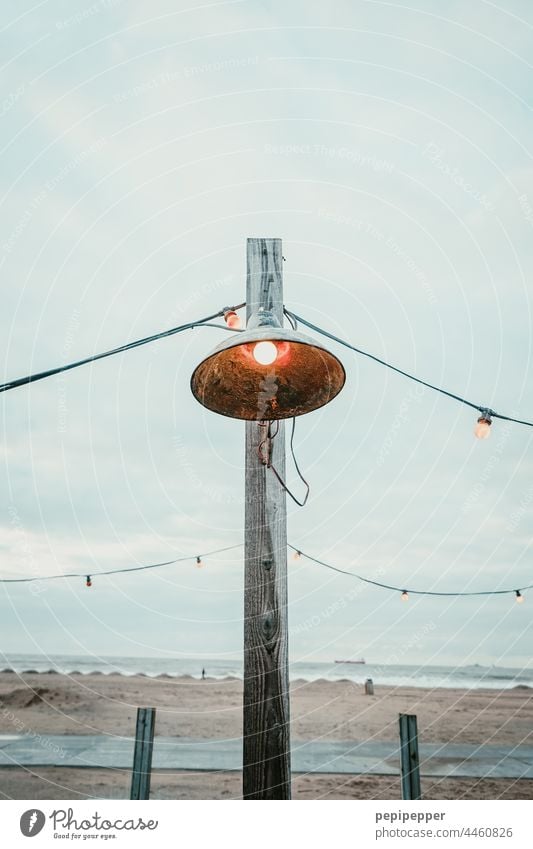 old street lamp by the sea Lamp Lampshades Lighting Electric bulb Ocean seascape Fairy lights Colour photo Exterior shot Illuminate Feasts & Celebrations