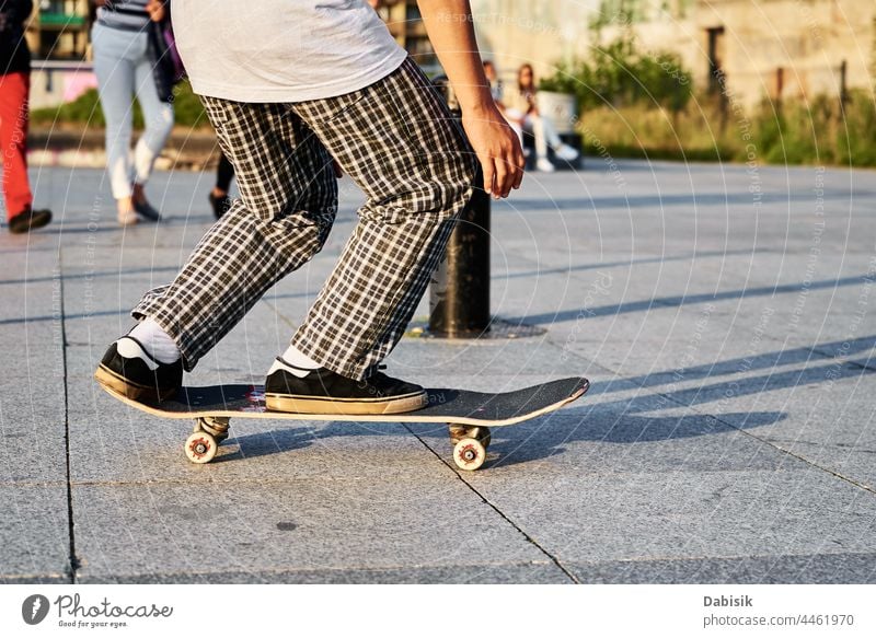 Skateboarder ride on skateboard at city street, close up skater sport boy hipster sneakers young shoes casual freestyle male streetwear action extreme fashion