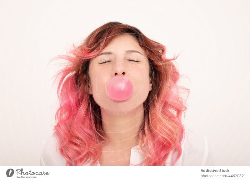 Positive female with pink bubble gum woman blow positive individuality cheerful delight joy appearance chew style happy optimist trendy pink hair fun bright