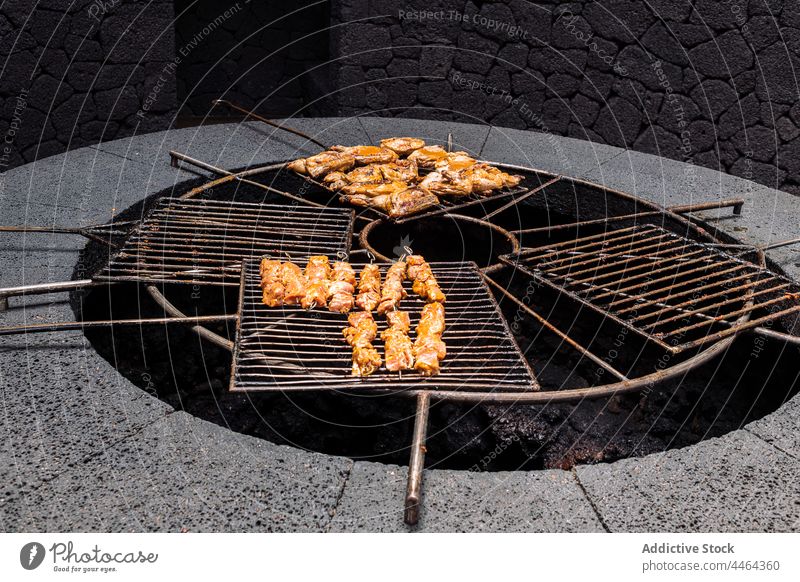 Chicken barbeque on rack chicken barbecue prepare grill volcano heat delicious aroma poultry protein piece cook island process stone material metal scent tasty
