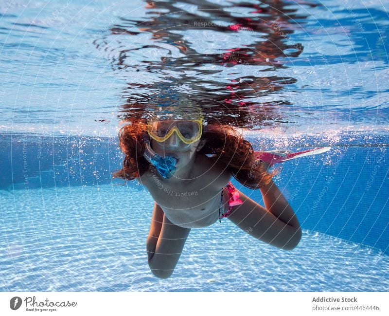 Girl in snorkeling mask swimming in pool girl underwater recreational activity childhood portrait swimsuit diving shirtless swimwear flipper fin equipment