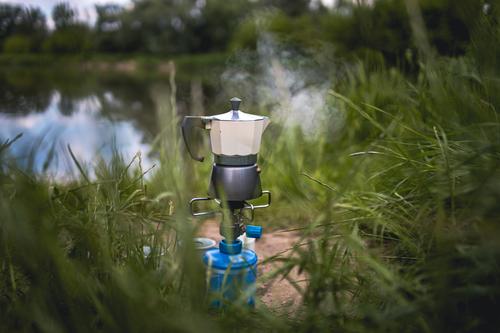 Making Coffee on Camping Gas in Nature cooking picnic making adventure morning coffee camping stove breakfast gas river nature making coffee coffee making