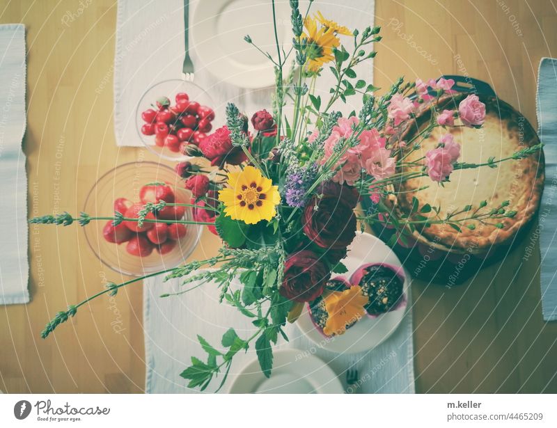 Bouquet of flowers on a coffee table with cheesecake Coffee table Crockery cheese cake Interior shot variegated from on high inboard Table decoration